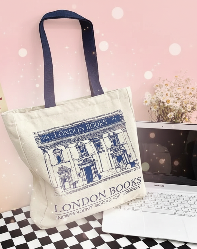 Tote bag with 'London Books' design on a desk with laptop and coffee cup