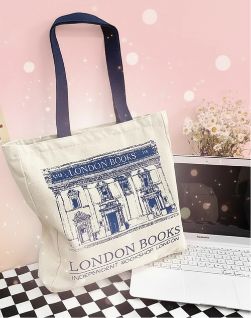 Tote bag with 'London Books' design on a desk with laptop and coffee cup