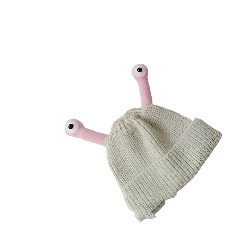Knitted green baby hat with pink dragon toy on a white background