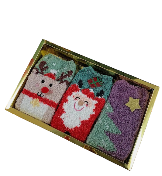 Set of Christmas-themed socks in a decorative box with festive decorations around.