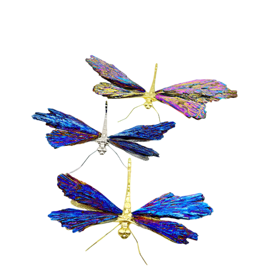 Three butterfly-shaped decorative items with iridescent wings on a white background