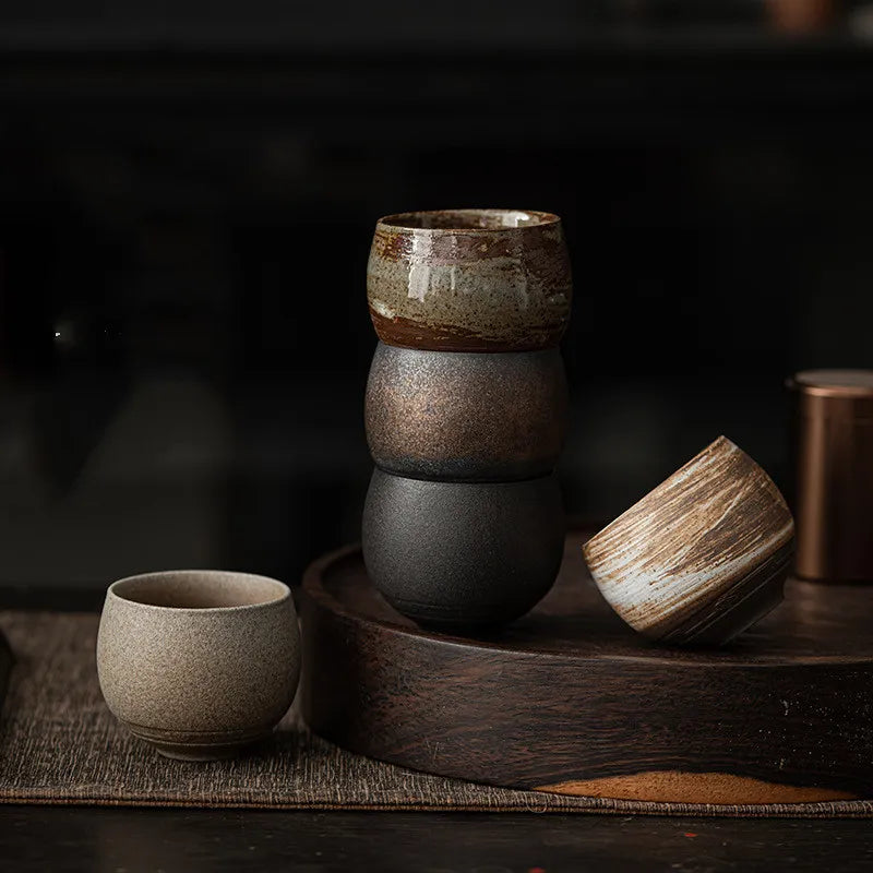 Stacked ceramic bowls on a wooden surface with a dark background