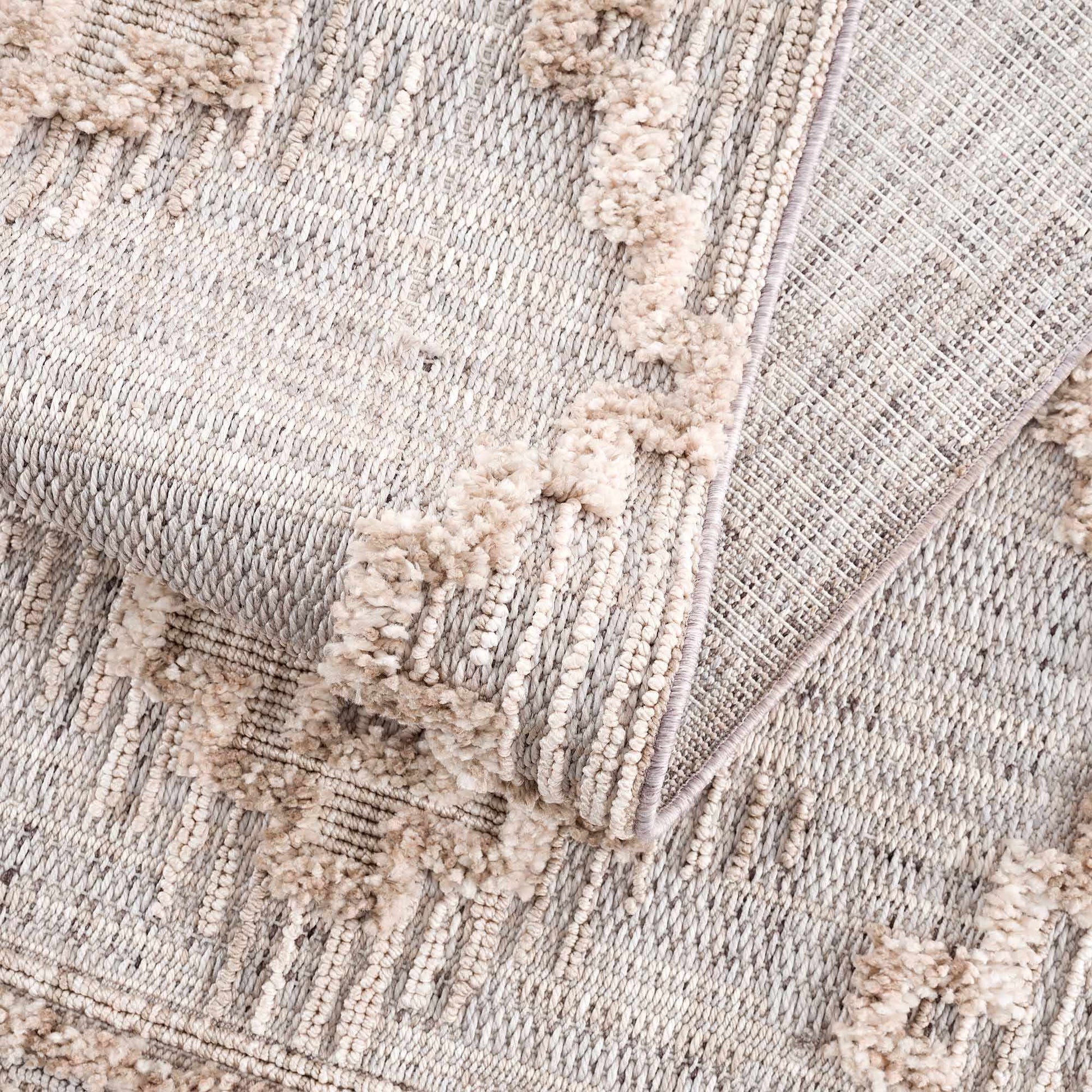 Close-up of a textured rug with a geometric pattern