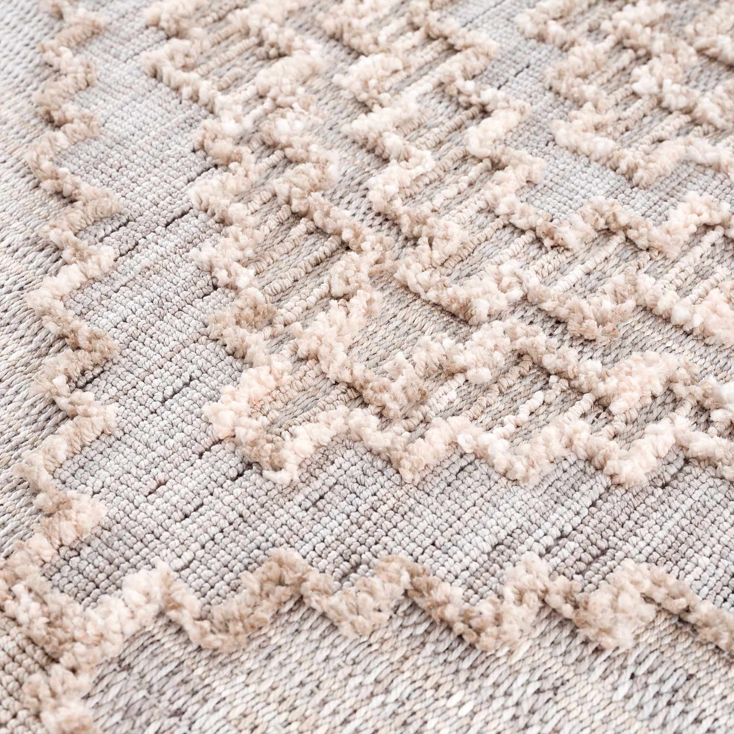 Close-up of a textured rug with a geometric pattern
