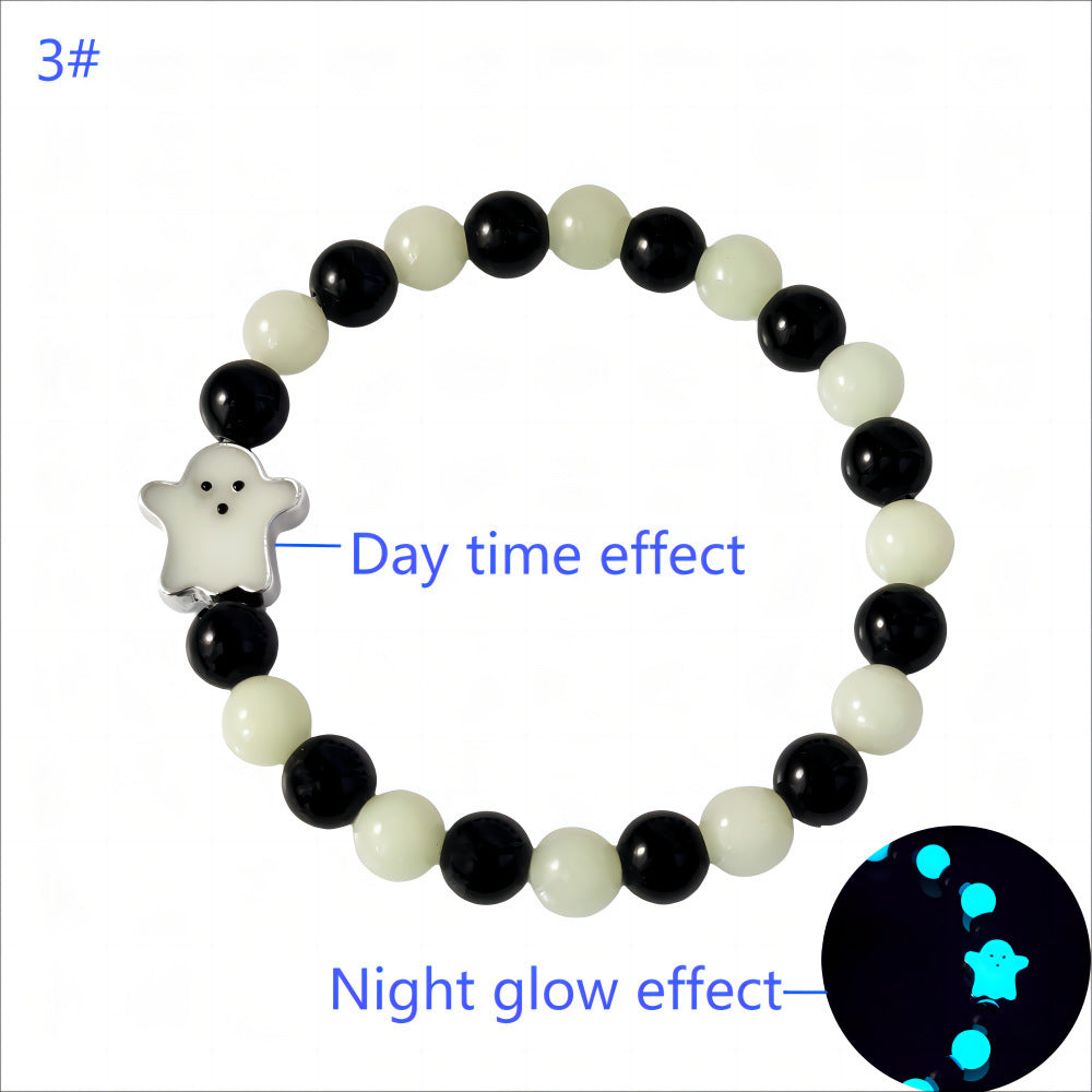 Bracelet with black and white beads and a star-shaped charm, showing day and night glow effects.
