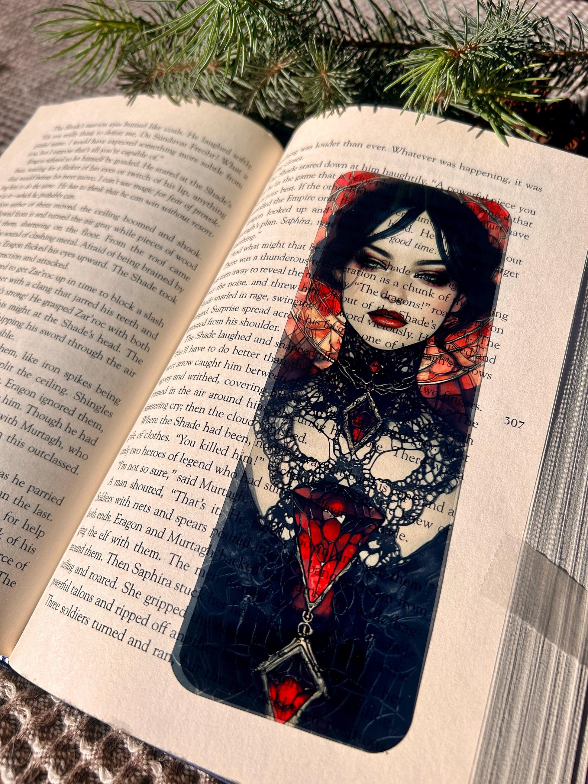 Decorative bookmark with a woman's face design on an open book