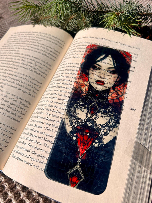Decorative bookmark with a woman's face design on an open book