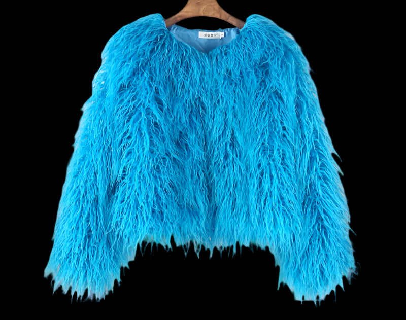 Blue fluffy sweater on a hanger against a wooden panel background