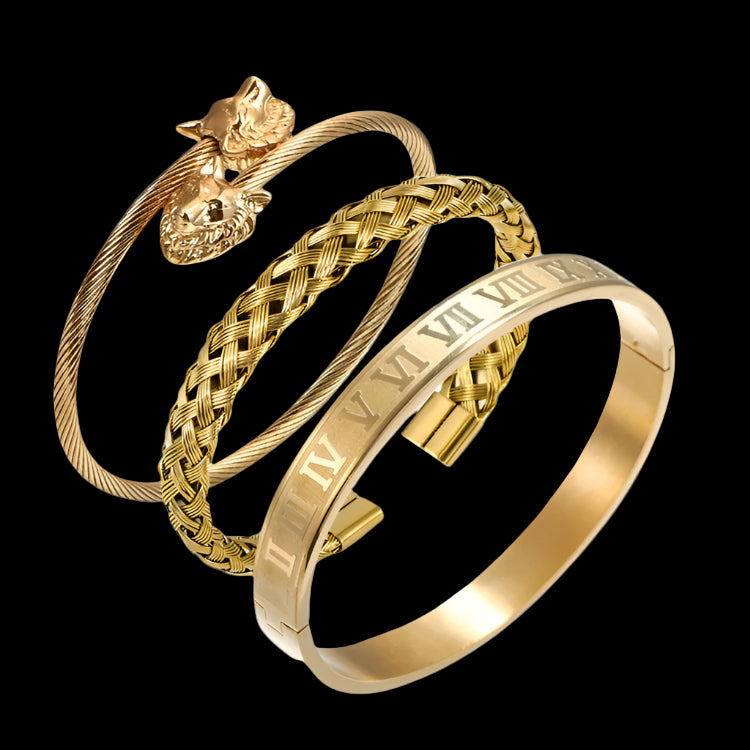 Two gold bracelets with braided design and Roman numeral detailing on a white background
