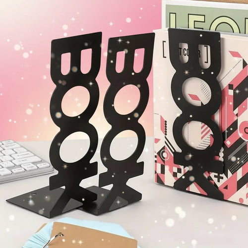 Black metal bookends shaped like books on a desk with a magazine and keyboard in the background.