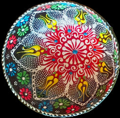 Colorful round pillow with intricate patterns on a textured background