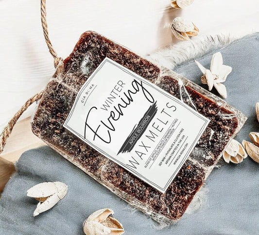 Wax melts packaging labeled 'Winter Evening' on a blue fabric background with decorative elements.