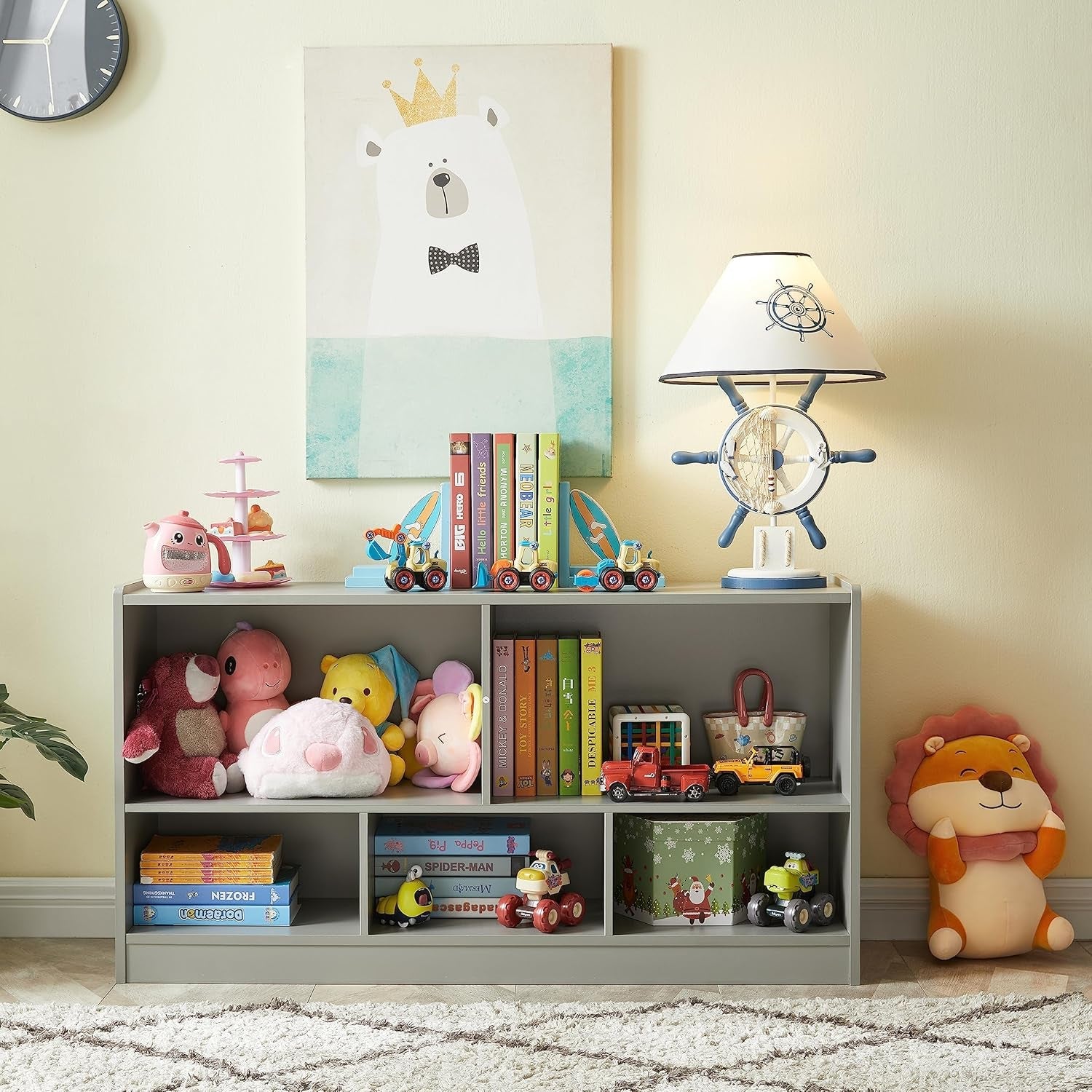 Children's room with a bookshelf filled with toys, books, and decorative items.