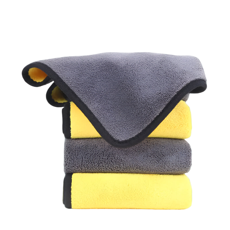 Stack of gray and yellow microfiber cloths on a white background