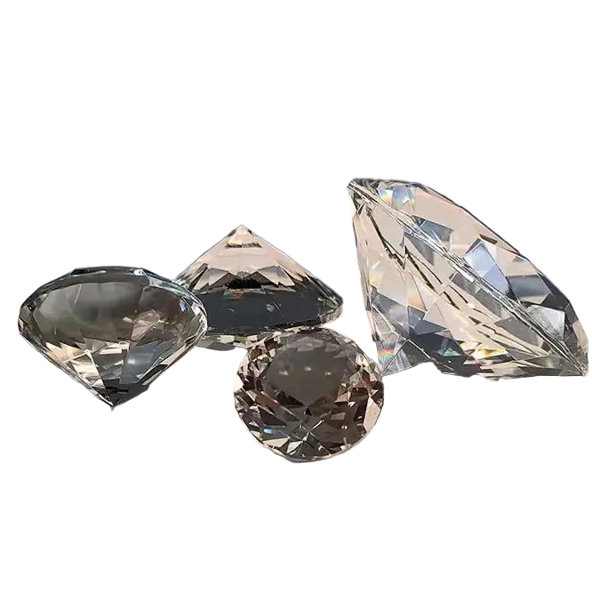 Four crystal-like objects on a reflective surface with a dark background