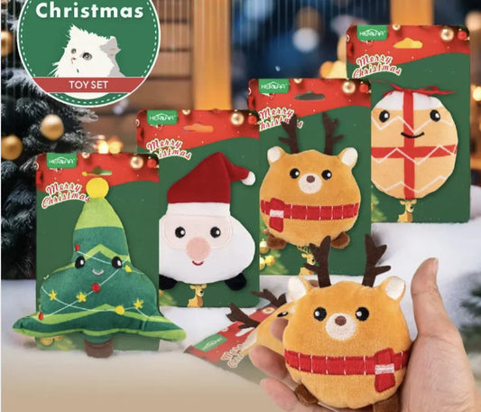 Collection of Christmas-themed cat toys with packaging, held by a hand.