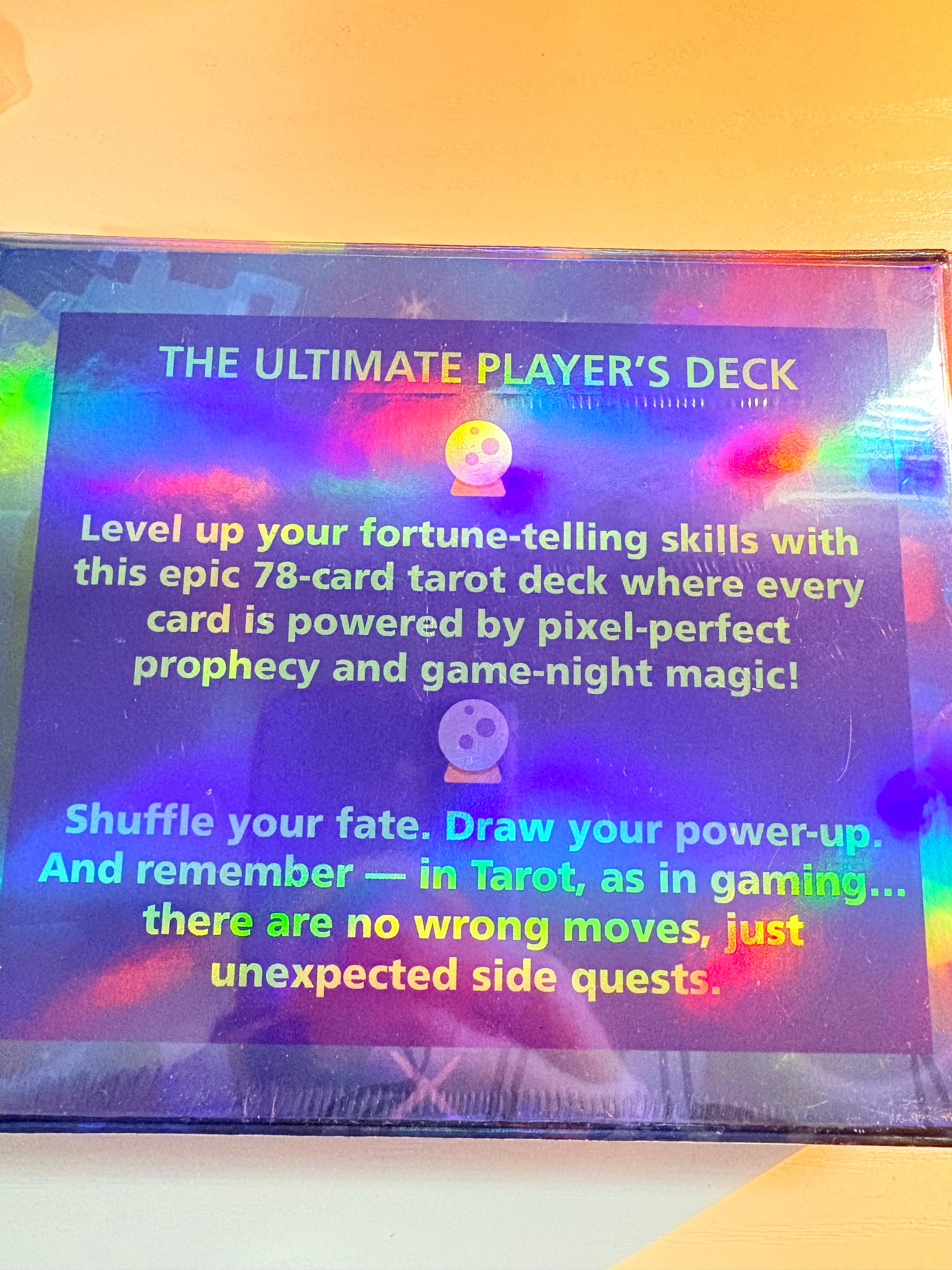 Holographic card packaging with text about 'The Ultimate Player's Deck' on a gradient background.