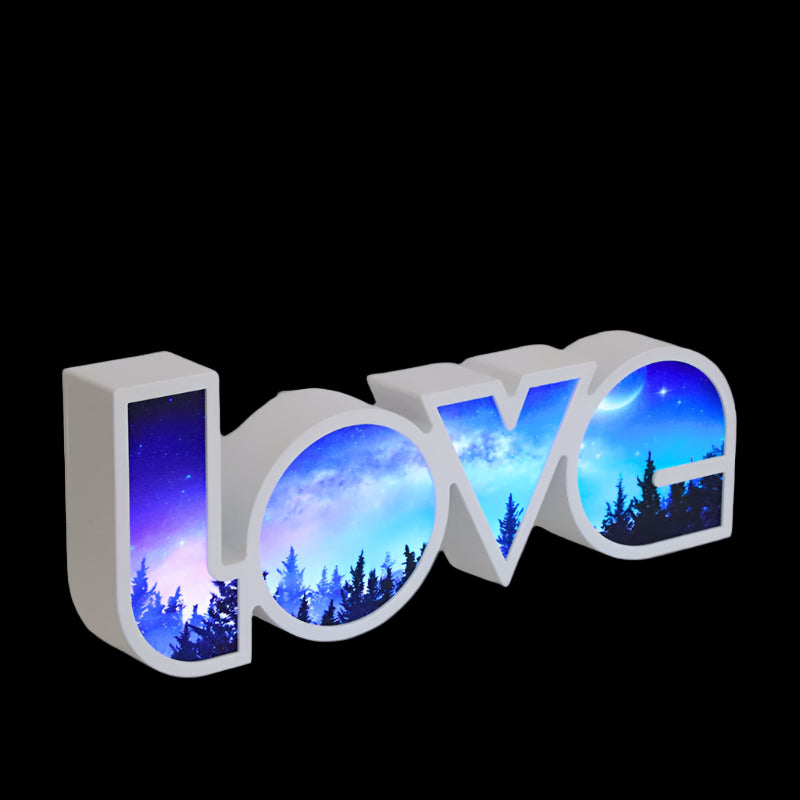 Decorative letters spelling 'HOME' with a night sky design on a white surface.