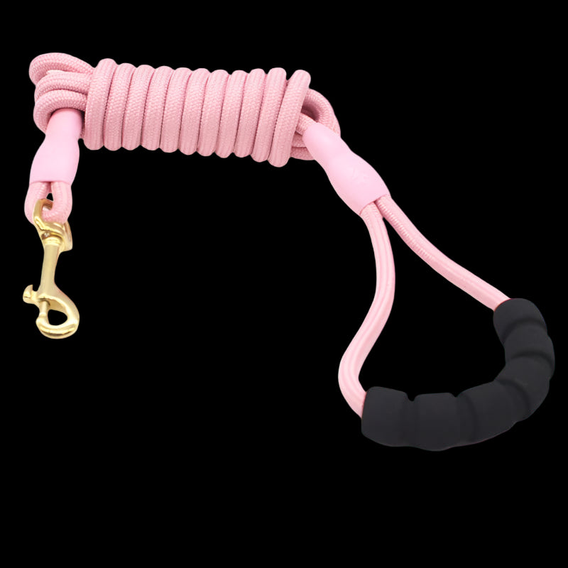 Pink dog leash with black handle and gold clasp on a white background