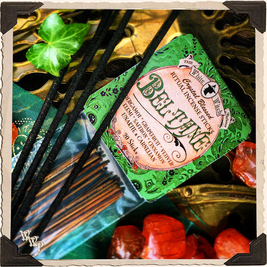 Pack of Beloved Incense Sticks with green packaging and black sticks on a decorative background.