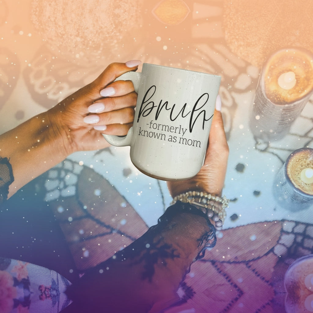 Person holding a mug with 'bruh, formerly known as mom' text on a decorative table with candles.