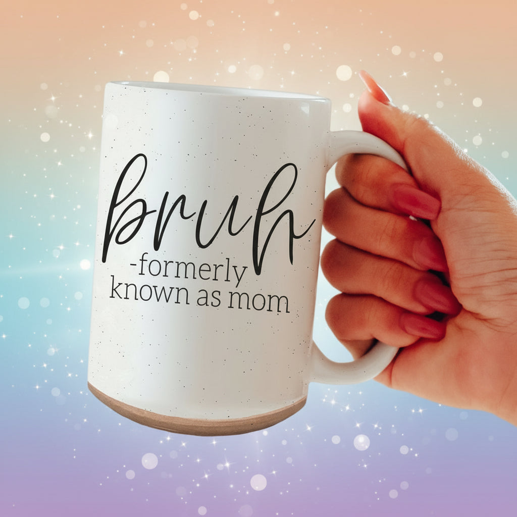 White mug with 'bruh - formerly known as mom' text held by a hand.