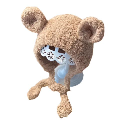 Brown teddy bear-shaped hat with a white lace detail on a white background