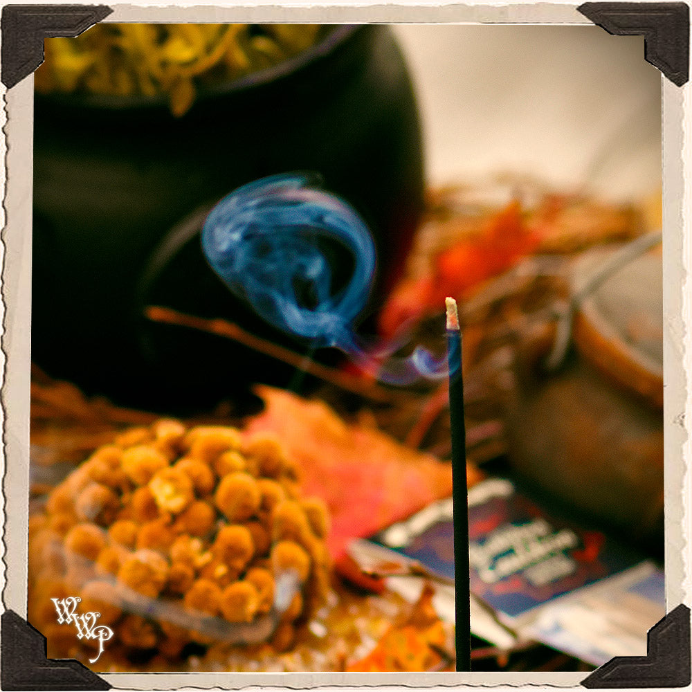 Halloween-themed setup with a cauldron, candle, and decorative elements.