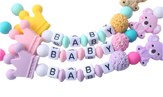 Colorful baby teething necklace with letters spelling 'BABY' on a white background