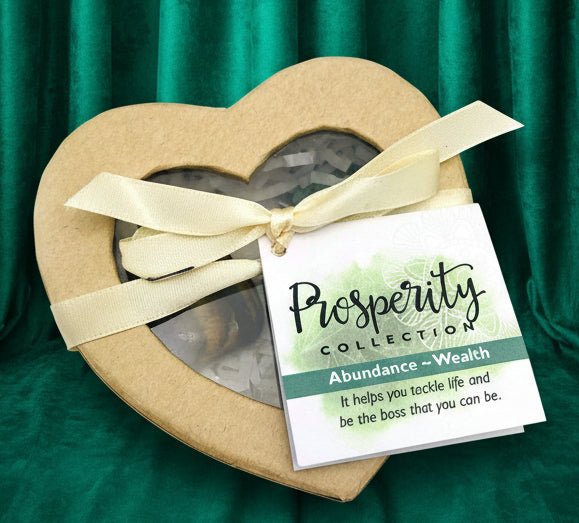 Heart-shaped box with a bow and a tag labeled 'Prosperity Collection' on a white background