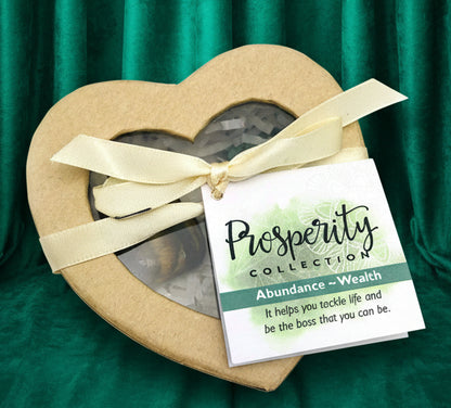 Heart-shaped box with a bow and a tag labeled 'Prosperity Collection' on a white background