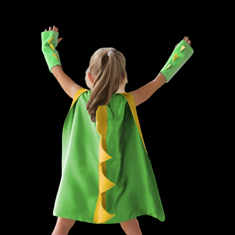 Child wearing a green superhero cape and gloves against a purple background