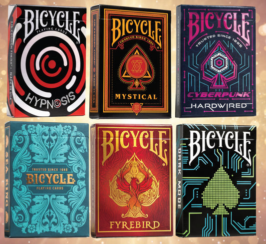 Six Bicycle playing card boxes with different designs and colors.
