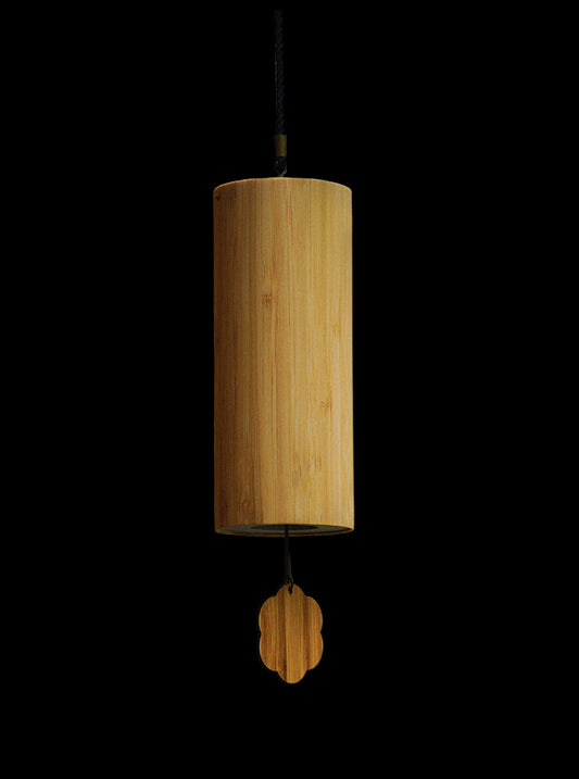 Wooden wind chime hanging against a blurred outdoor background