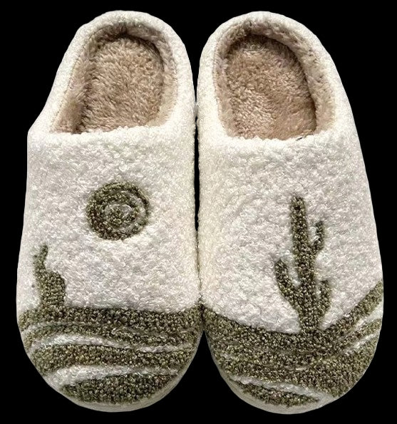 Pair of white slippers with green patterns on a white background