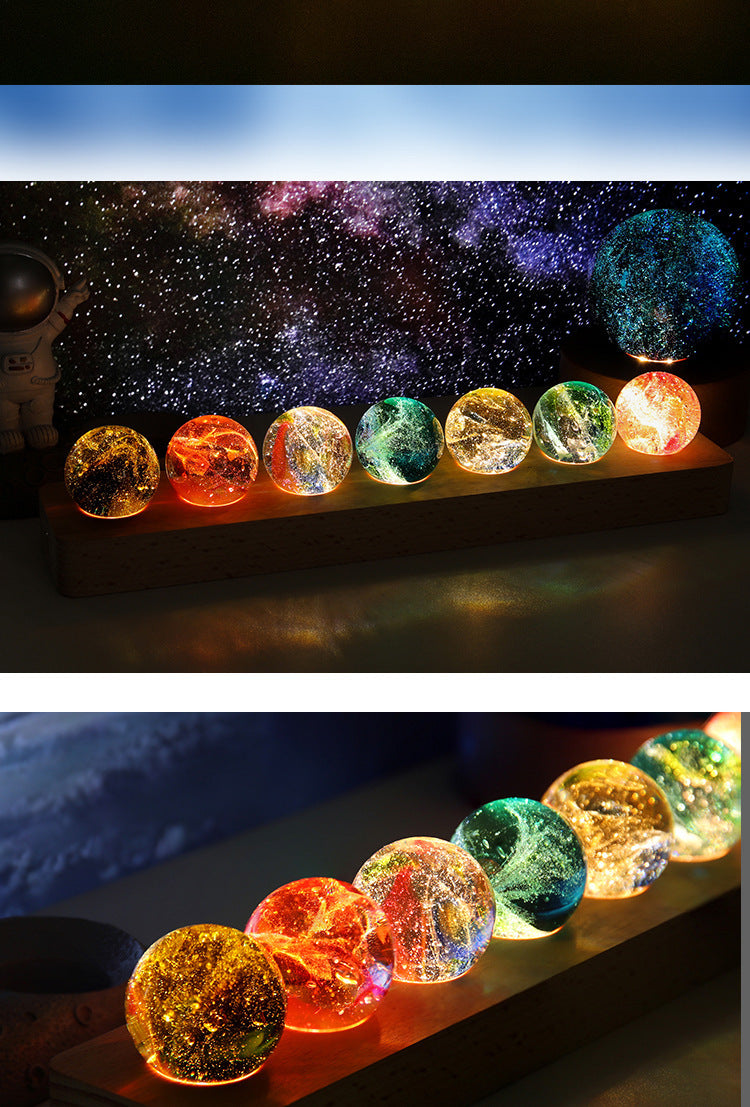 Colorful glass balls on a stand with a starry night sky background
