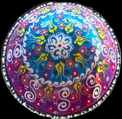 Colorful round cushion with intricate patterns on a multicolored background