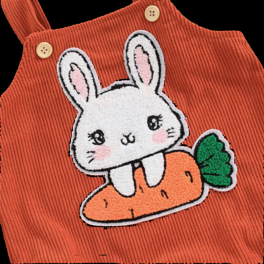 Orange corduroy dress with a bunny and carrot patch on a beige background