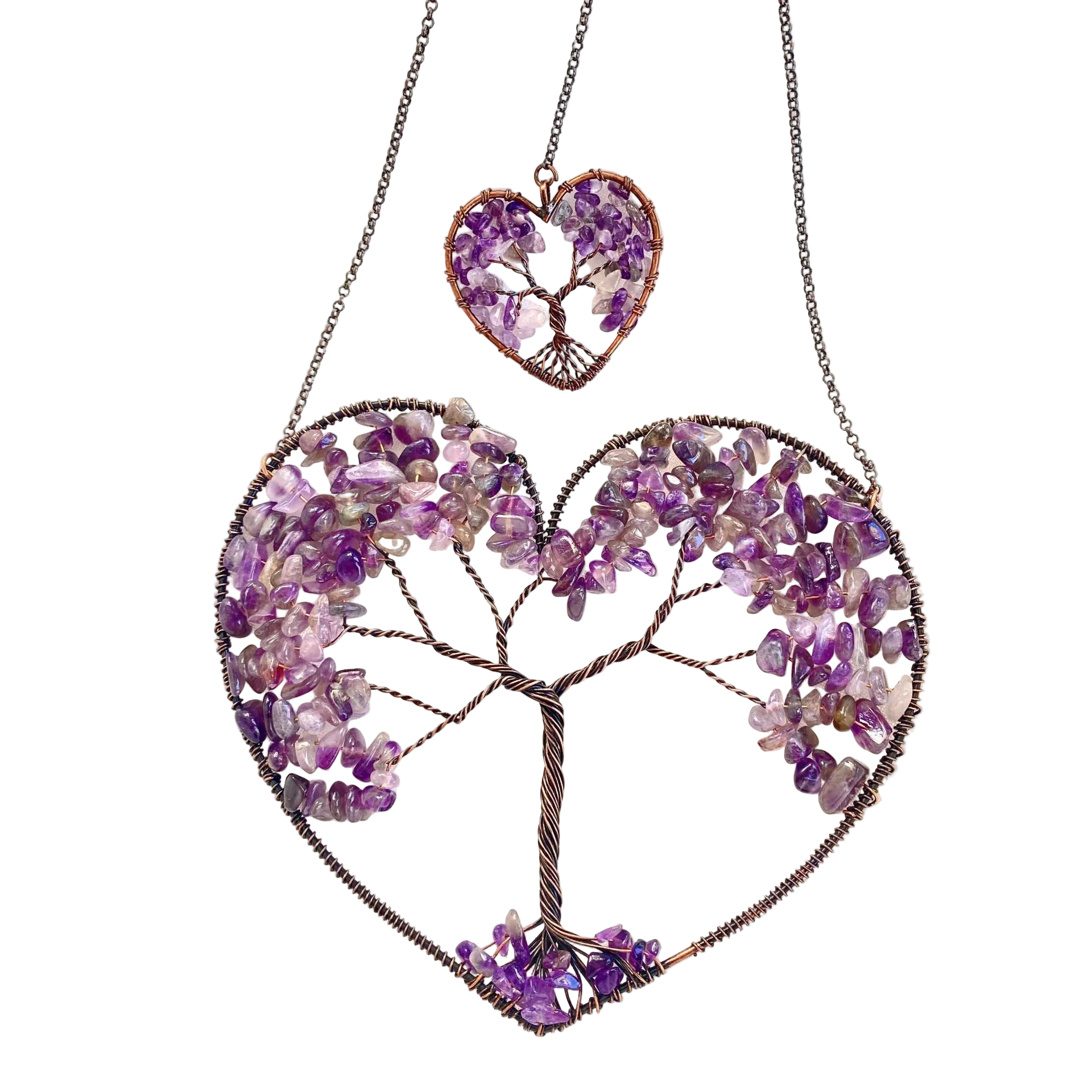 Heart-shaped jewelry with tree design made of purple stones on a white background