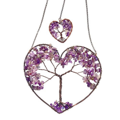 Heart-shaped jewelry with tree design made of purple stones on a white background