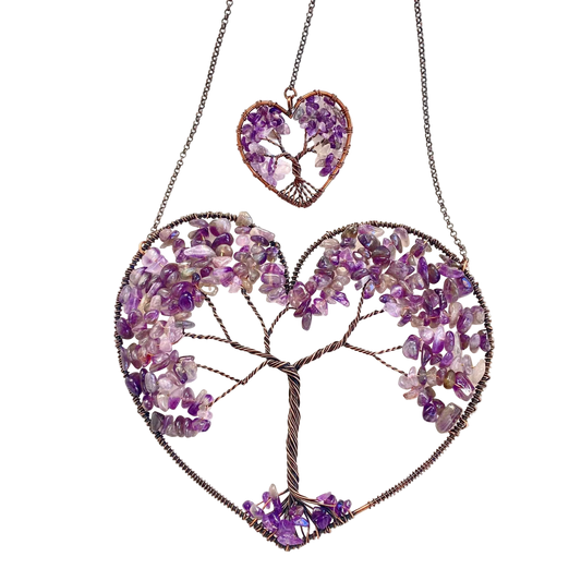 Heart-shaped jewelry with tree design made of purple stones on a white background