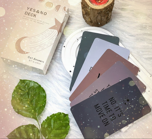 Set of cards with motivational phrases on a white surface with leaves and a candle.