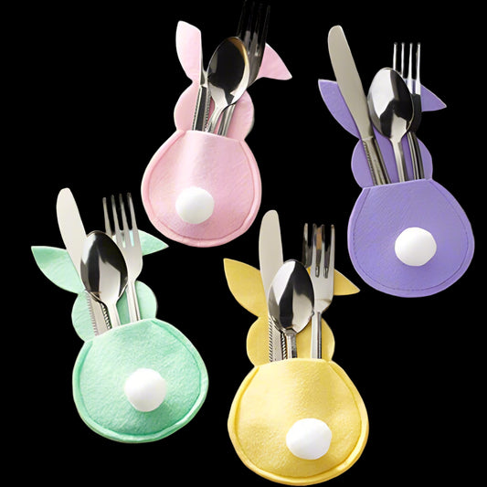 Colorful bunny-shaped cutlery holders with silverware on a wooden table.