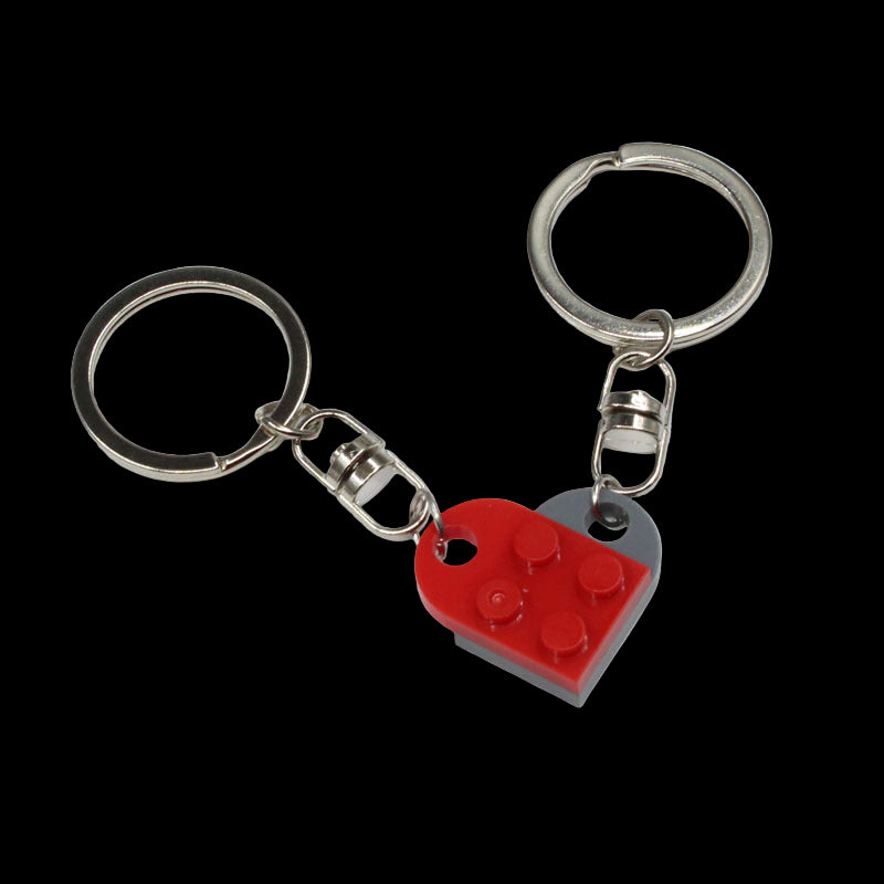 Keychain with red heart-shaped and gray square-shaped charms on a white background