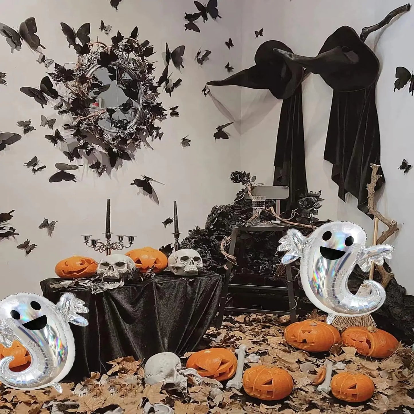 Halloween-themed room with decorations including ghosts, pumpkins, and a witch.
