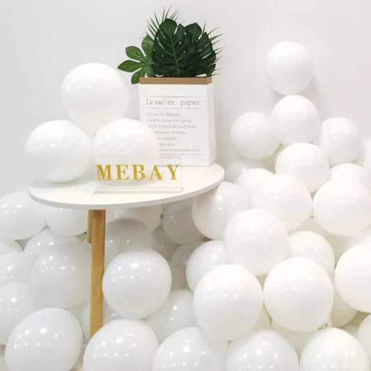 White balloons with a small table and plant in the center against a white background