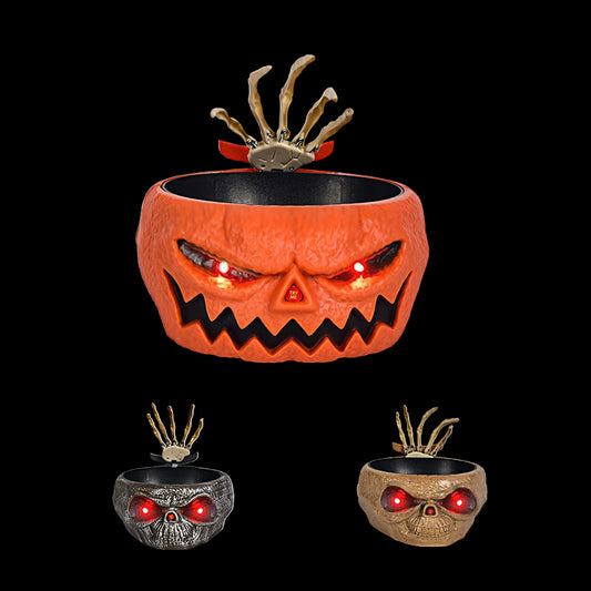 Halloween-themed pumpkin with glowing red eyes in a dark cemetery setting