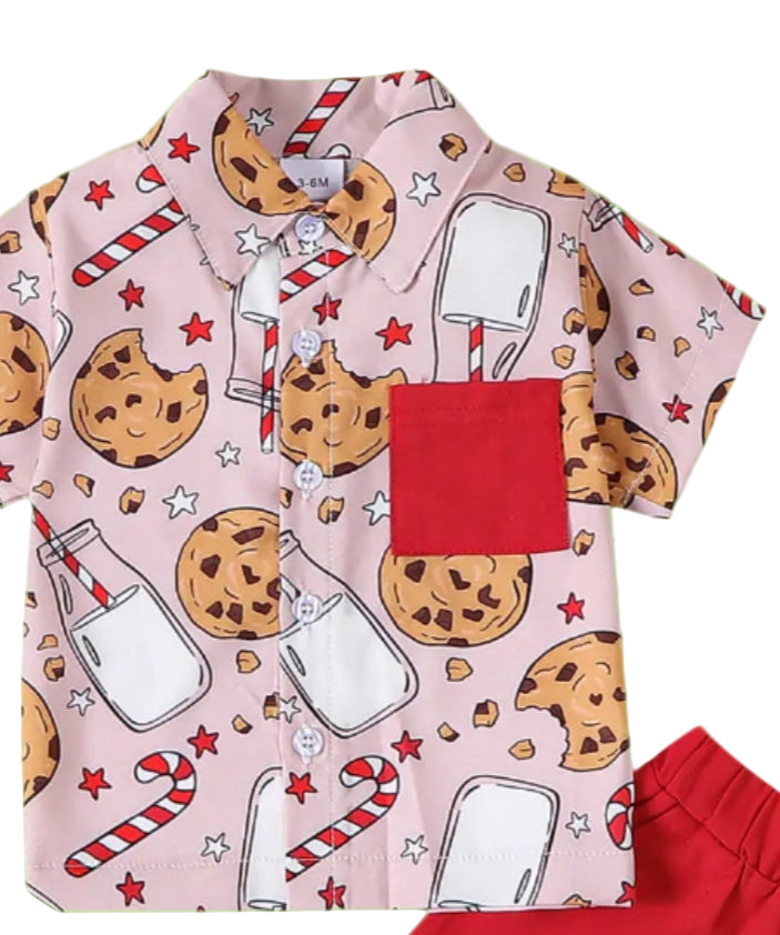 Children's outfit with cookie-themed shirt and red shorts on a white background