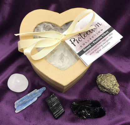 Heart-shaped gift box with crystals and a ribbon on a white background