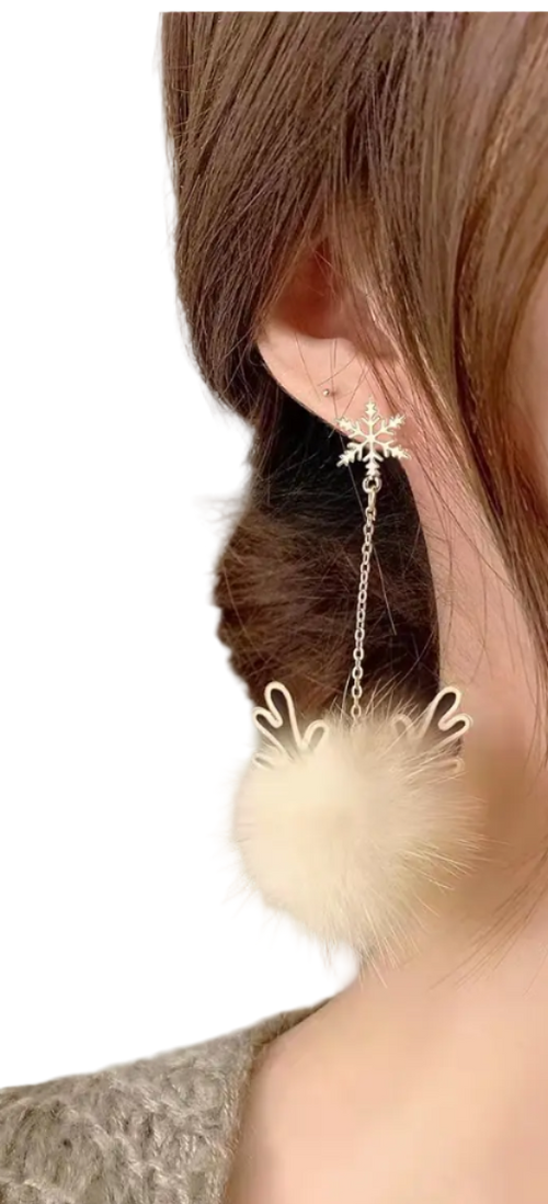 Close-up of a person wearing a fluffy earring with a neutral background